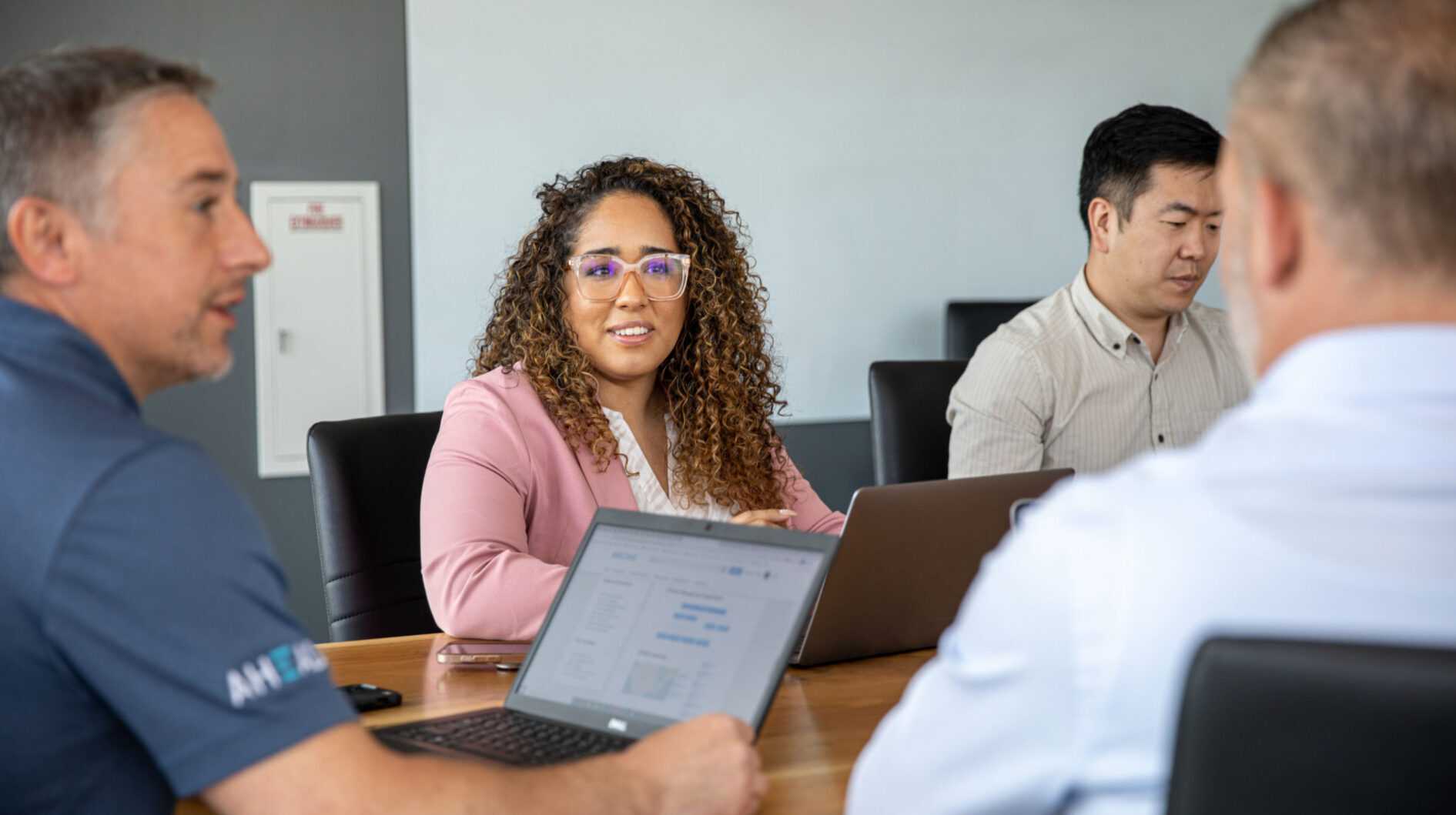 A group of people coworking together in a conference room