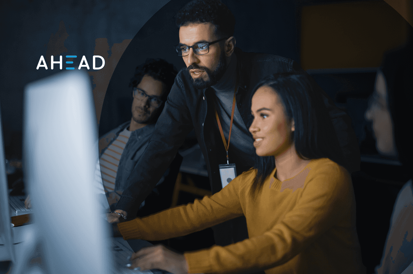 Three people looking at a computer desktop