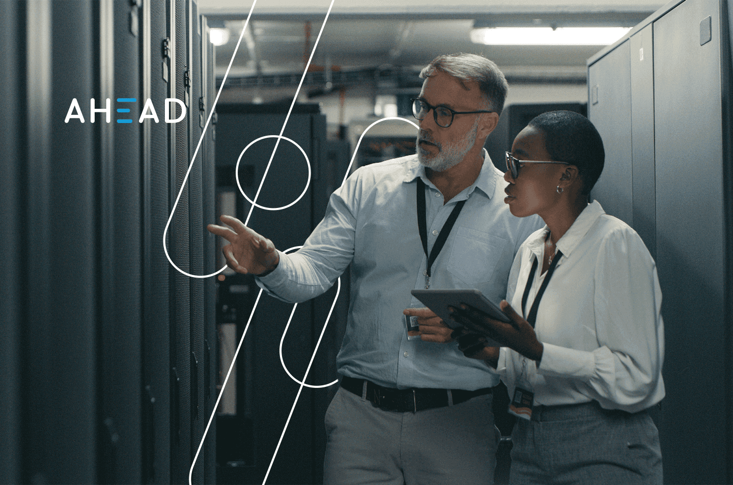 a man and a woman looking at data storage racks