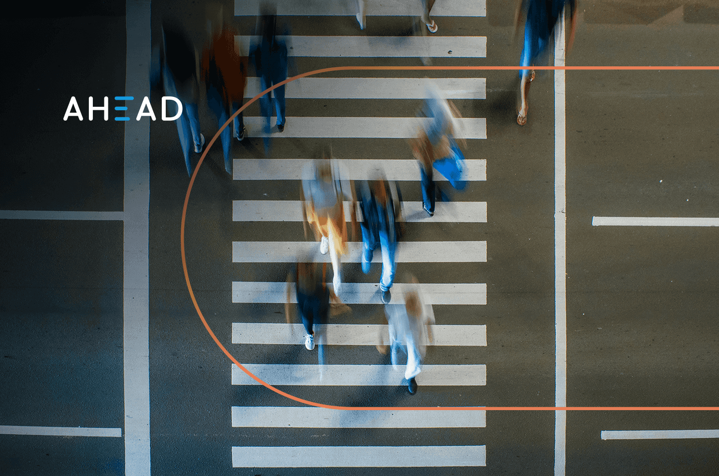 an arial view of people walking across a crosswalk with motion blur