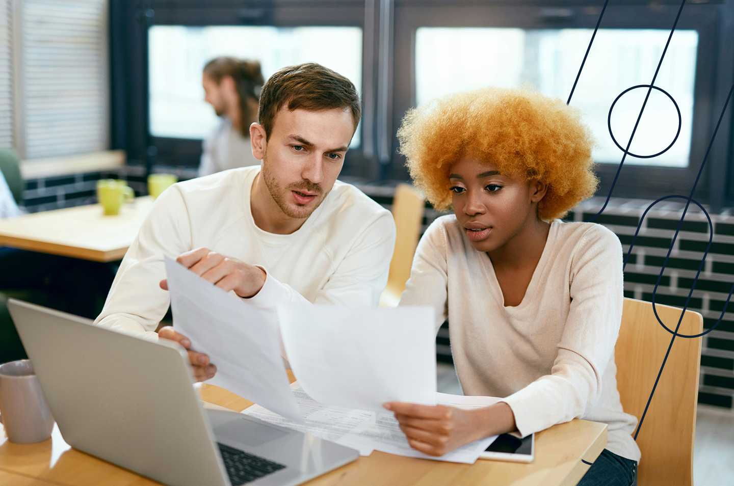 Two people sitting together looking at a computer