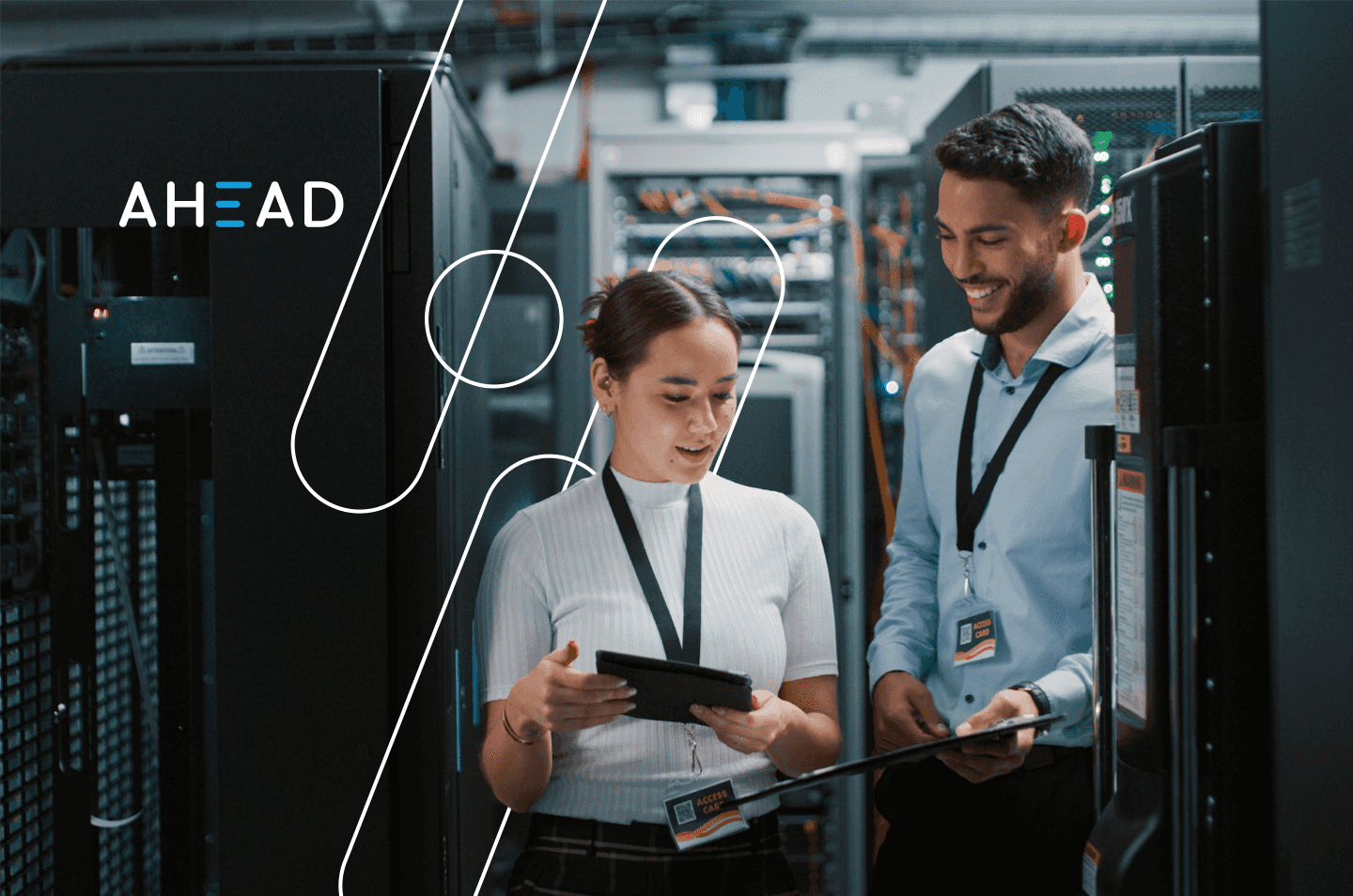 two people standing inside a data center looking at a tablet